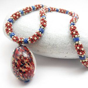 Blown glass pendant necklace with handweaving and Lapis